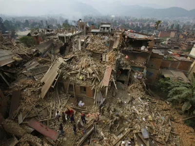 FILE &mdash; In this Sunday, April 26, 2015 file photo, rescue workers remove debris as they search for victims of an earthquake in Bhaktapur, Nepal. (AP Photo/Niranjan Shrestha, File)