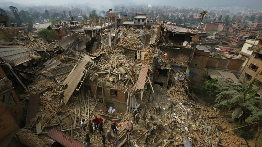 FILE &mdash; In this Sunday, April 26, 2015 file photo, rescue workers remove debris as they search for victims of an earthquake in Bhaktapur, Nepal. (AP Photo/Niranjan Shrestha, File)