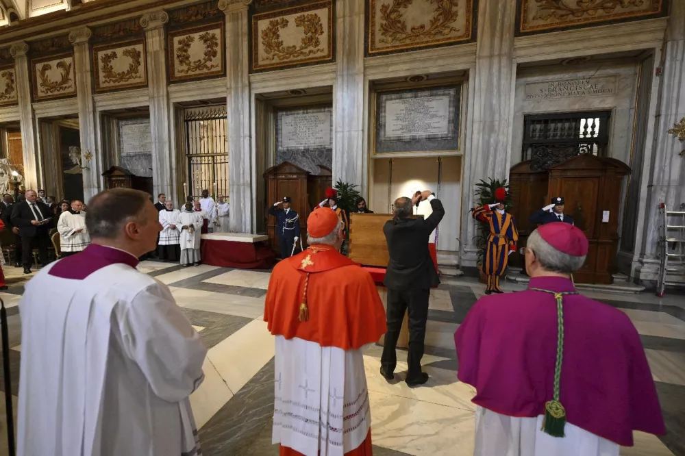 Cardinal Camerlengo Kevin Joseph Farrell, center, and Vatican Master of Ceremonies Archbishop Diego Giovanni Ravelli, right, preside over the burial ceremony of late Pope Francis inside St. Mary Major Basilica in Rome Saturday, April 26, 2025. (Vatican Media via AP)