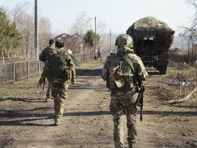 In this photo taken from video distributed by Russian Defense Ministry Press Service on Friday, March 14, 2025, Russian soldiers patrol an area in the Kursk region of Russia after it was taken over by Russian troops. (Russian Defense Ministry Press Service via AP)
