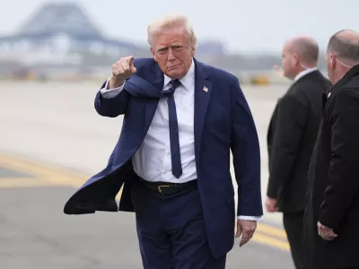 President Donald Trump points as he arrives at Newark Liberty International Airport in Newark, N.J., Saturday, April 26, 2025, upon returning from a trip to attend the funeral of Pope Francis at the Vatican. (AP Photo/Evan Vucci)