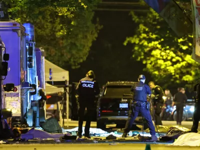 Vancouver Police forensics officers investigate the scene of a suspect vehicle and bodies of victims lying covered on the ground, after it drove into a crowd at a Lapu Lapu day block party, in which police say multiple people were killed and injured, in Vancouver, Canada April 27, 2025. REUTERS/Chris Helgren