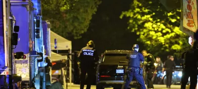 Vancouver Police forensics officers investigate the scene of a suspect vehicle and bodies of victims lying covered on the ground, after it drove into a crowd at a Lapu Lapu day block party, in which police say multiple people were killed and injured, in Vancouver, Canada April 27, 2025. REUTERS/Chris Helgren