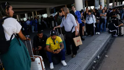 Travellers wait outside Atocha train station with their luggage after it was closed due to a power outage in Madrid, Spain, April 28, 2025. REUTERS/Susana Vera