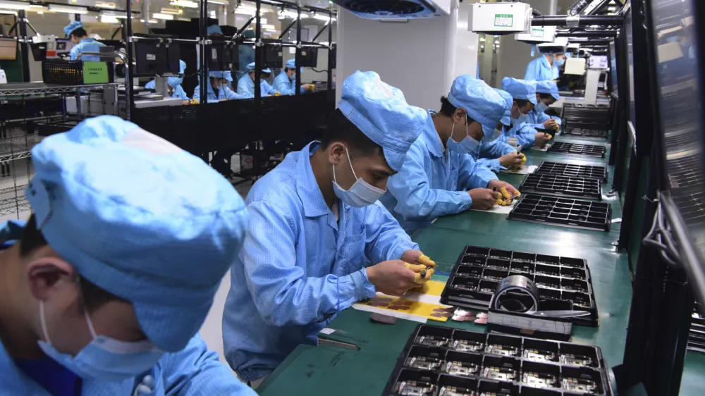 ﻿In this Feb. 13, 2020, photo released by Xinhua News Agency, workers wearing masks labor at a factory for Chinese telecommunications company OPPO in Dongguan, in southern China's Guangdong Province. Factories in China, struggling to reopen after the coronavirus shut down the economy, face a new threat from U.S. anti-disease controls that might disrupt the flow of microchips and other components they need. For most people, the new coronavirus causes only mild or moderate symptoms. For some it can cause more severe illness. (Chen Yuxuan/Xinhua via AP)