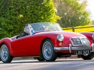 2X2D8AK Bicester,UK- Apr 21st2024: 1959 red MGA classic car driving on a British road