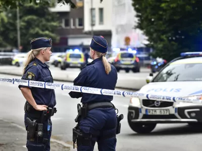 ﻿Police stand next to a cordon in central Malmo, southern Sweden, Monday, June 18, 2018. A Swedish newspaper is reporting that four people have injured in a shooting near a police station in the southern city of Malmo. Witnesses told newspaper Aftonbladet they heard what sounded like 15 to 20 shots about 6:15 p.m. in the city center.(Johan Nilsson/TT News Agency via AP)