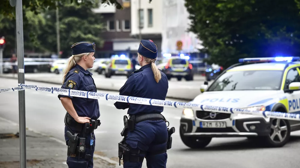 ﻿Police stand next to a cordon in central Malmo, southern Sweden, Monday, June 18, 2018. A Swedish newspaper is reporting that four people have injured in a shooting near a police station in the southern city of Malmo. Witnesses told newspaper Aftonbladet they heard what sounded like 15 to 20 shots about 6:15 p.m. in the city center.(Johan Nilsson/TT News Agency via AP)