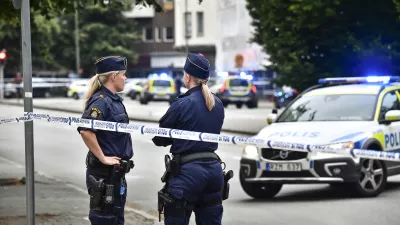 ﻿Police stand next to a cordon in central Malmo, southern Sweden, Monday, June 18, 2018. A Swedish newspaper is reporting that four people have injured in a shooting near a police station in the southern city of Malmo. Witnesses told newspaper Aftonbladet they heard what sounded like 15 to 20 shots about 6:15 p.m. in the city center.(Johan Nilsson/TT News Agency via AP)
