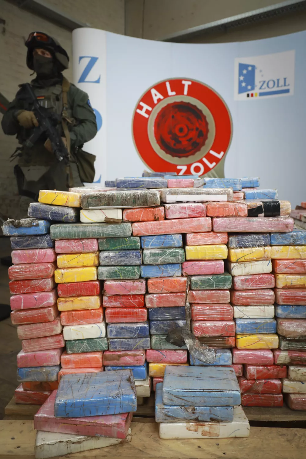 ﻿A heavily armed customs officials from a special unit guards a record haul of 3.8 tons of cocaine they seized in shipping containers from South America in three operations earlier this year, at a press conference in Hamburg, Germany, Thursday, July 20, 2017. (Christian Charisius/dpa via AP)