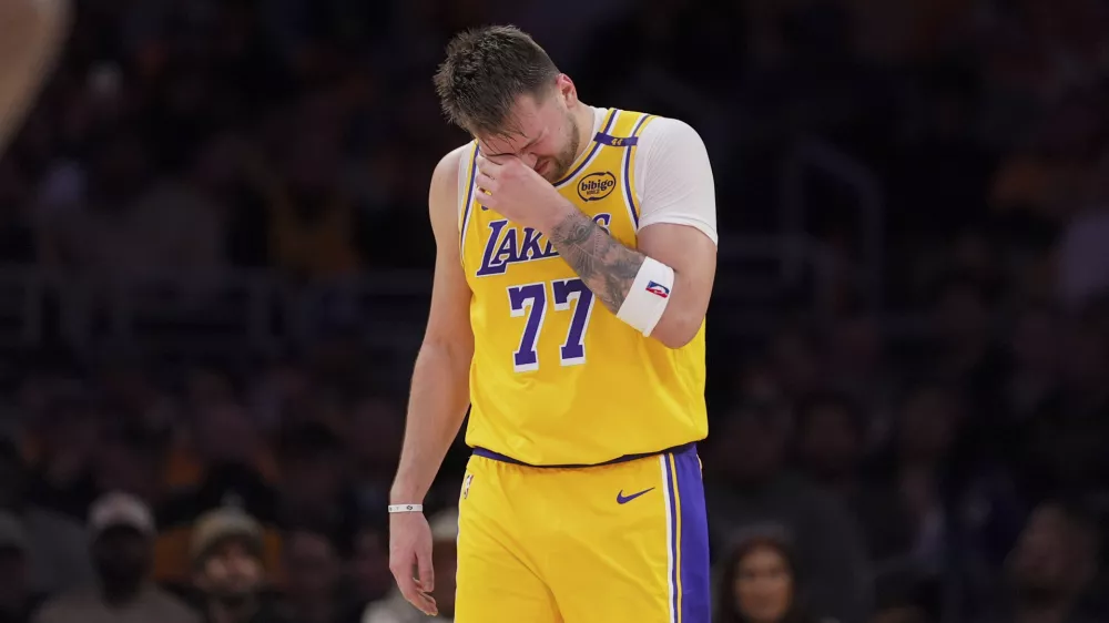 Los Angeles Lakers guard Luka Doncic wipes his face during the second half of an NBA basketball game against the Utah Jazz, Monday, Feb. 10, 2025, in Los Angeles. (AP Photo/Mark J. Terrill)