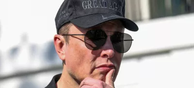 FILE PHOTO: Tesla CEO Elon Musk looks on next to U.S. President Donald Trump talking to the media, at the White House in Washington, D.C., U.S., March 11, 2025. REUTERS/Kevin Lamarque/File Photo