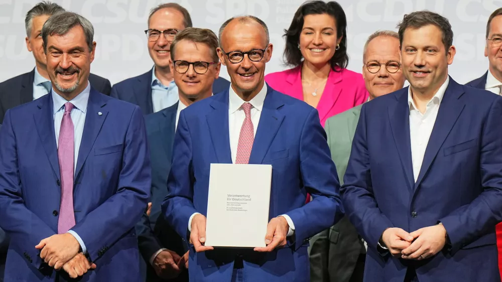 05 May 2025, Berlin: Christian Democratic Union (CDU) Chairman and candidate for Chancellor Friedrich Merz (C), Christian Social Union Chairman Markus Soeder (L) and Social Democratic Party (SPD) Chairman Lars Klingbeil, designated German Minister of Finance and Vice-Chancellor, pose for a photo after signing the coalition agreement between the CDU, CSU and SPD to form a new federal government. Photo: Michael Kappeler/dpa