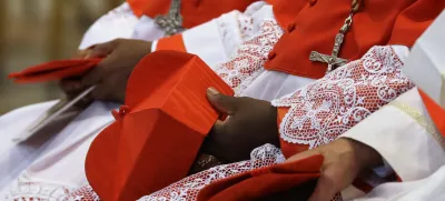 FILE - Cardinals hold the red three-cornered biretta hats before a consistory inside the St. Peter's Basilica at the Vatican, Saturday, Nov. 19, 2016. (AP Photo/Gregorio Borgia, File)