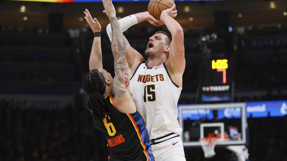 Denver Nuggets' Nikola Jokic (15) is fouled taking a shot by Oklahoma City Thunder's Jaylin Williams (6) in the first half of Game 1 of an NBA basketball second-round playoff series Monday, May 5, 2025, in Oklahoma City. (AP Photo/Nate Billings)