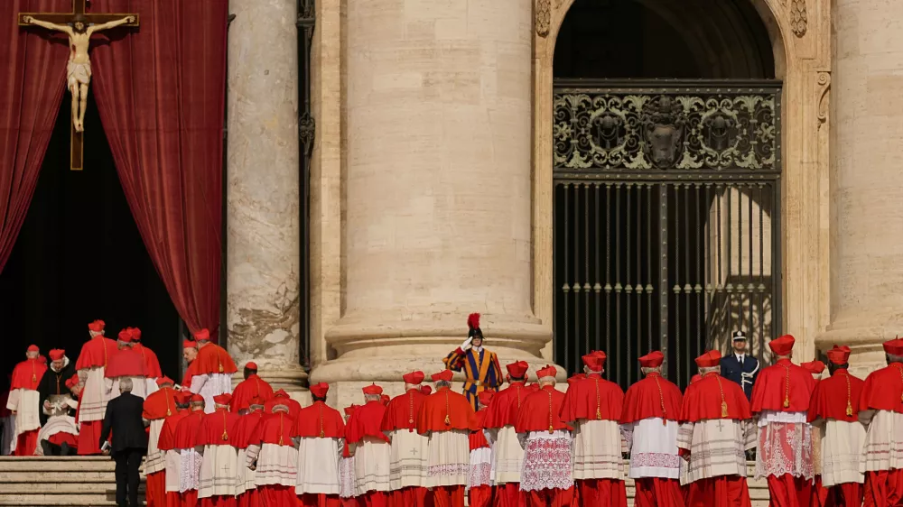 FILE - Cardinals walk through St. Peter's Square ahead of Pope Francis' coffin at the Vatican, Wednesday, April 23, 2025. (AP Photo/Andreea Alexandru, File)