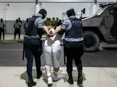 Salvadoran prison guards escort a man as the alleged members of the Venezuelan gang Tren de Aragua and the MS-13 gang recently deported by the U.S. government are to be imprisoned in the Terrorism Confinement Center (CECOT) prison, in Tecoluca, El Salvador April 12, 2025. Secretaria de Prensa de la Presidencia/Handout via REUTERS ATTENTION EDITORS-THIS IMAGE HAS BEEN SUPPLIED BY A THIRD PARTY. NO RESALES. NO ARCHIVES.