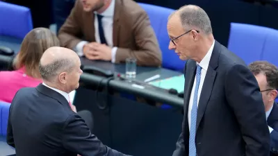 06 May 2025, Berlin: Acting Federal Chancellor Olaf Scholz shakes hands with Chancellor candidate Friedrich Merz during the second round of Chancellor election. Merz failed the first round of voting in the Bundestag. Photo: Kay Nietfeld/dpa