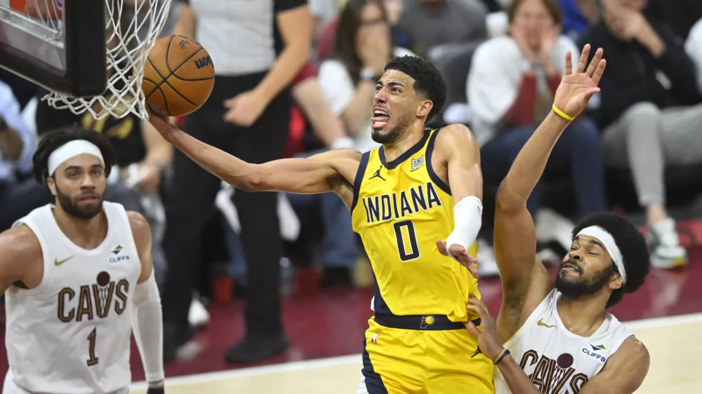 May 6, 2025; Cleveland, Ohio, USA; Indiana Pacers guard Tyrese Haliburton (0) drives to the basket between guard Max Strus (1) and center Jarrett Allen (31) in the fourth quarter during game two of the second round of the 2025 NBA Playoffs at Rocket Arena. Mandatory Credit: David Richard-Imagn Images