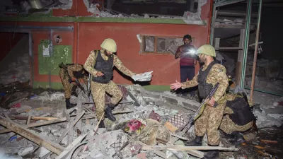 Army soldiers inspect a building damaged by a suspected Indian missile attack near Muzaffarabad, the capital of Pakistan controlled Kashmir, Wednesday, May 7, 2025. (AP Photo/M.D. Mughal)