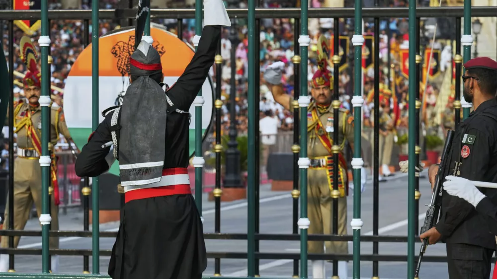 Pakistan's Rangers soldier, in black, and Indian Border Security Forces soldier, gesture to each other during a daily closing ceremony at the Wagah, a joint post on the Pakistan and India border, near Lahore, Pakistan, Saturday, May 3, 2025. (AP Photo/K.M. Chaudary)