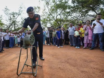 A Civil defense member blows the siren carry out a mock drill to train civilians and security personnel to respond in case of attack, in Guwahati, India, Wednesday, May 7, 2025 amid rising fears of wider conflict following India's strikes in Pakistan. (AP Photo/Anupam Nath)