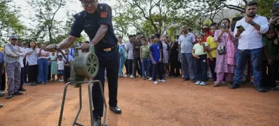 A Civil defense member blows the siren carry out a mock drill to train civilians and security personnel to respond in case of attack, in Guwahati, India, Wednesday, May 7, 2025 amid rising fears of wider conflict following India's strikes in Pakistan. (AP Photo/Anupam Nath)