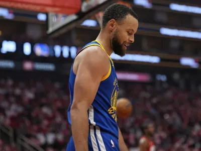 Golden State Warriors guard Stephen Curry looks down after a foul during the first half of Game 5 of an NBA basketball first-round playoff series against the Houston Rockets, Wednesday, April 30, 2025, in Houston. (AP Photo/David J. Phillip)
