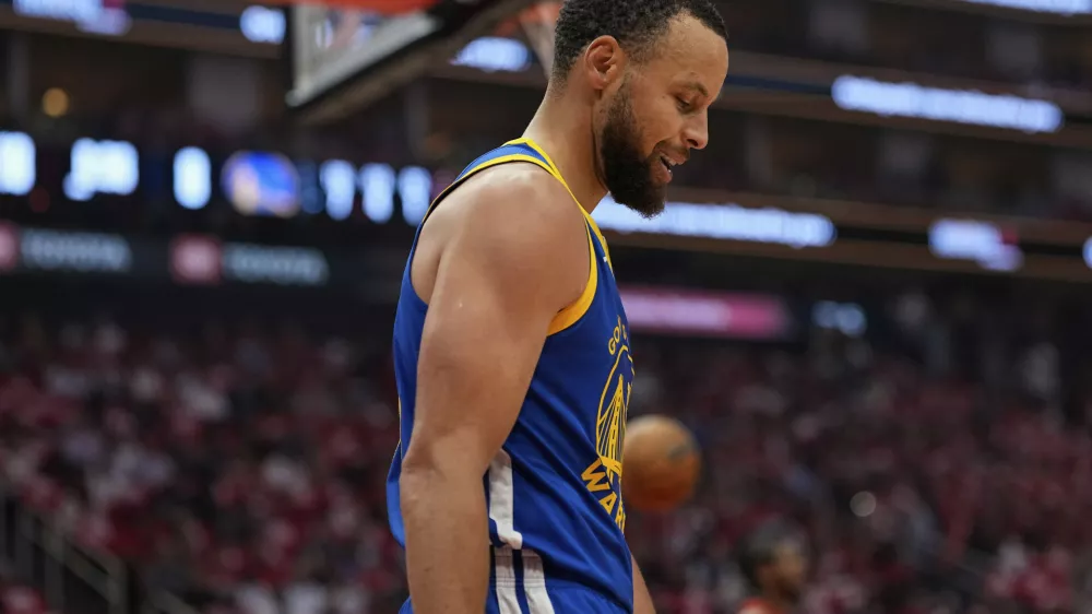 Golden State Warriors guard Stephen Curry looks down after a foul during the first half of Game 5 of an NBA basketball first-round playoff series against the Houston Rockets, Wednesday, April 30, 2025, in Houston. (AP Photo/David J. Phillip)