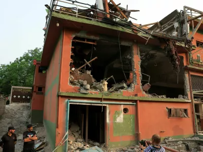 Police officers look on as a cameraman films the Bilal Mosque, after it was hit by an Indian strike in Muzaffarabad, the capital of Pakistan-administered Kashmir, May 7, 2025. REUTERS/Akhtar Soomro