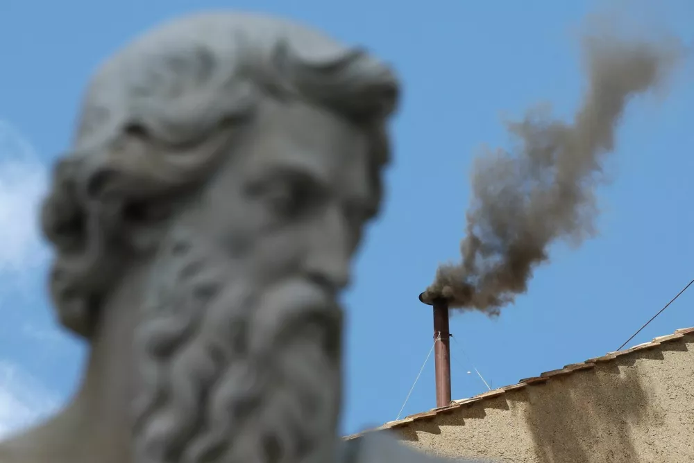 Black smoke rises from the chimney on the Sistine Chapel, indicating no decision has been made to elect a new pope, at the Vatican, May 8, 2025. REUTERS/Guglielmo Mangiapane
