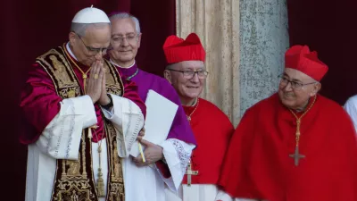 Newly elected Pope Leo XIV, left, formerly Cardinal Robert Francis Prevost, appears with, from left, Master of Ceremonies Archbishop Diego Giovanni Ravelli, Cardinal Pietro Parolin, and Cardinal Vinko Puljić on the central loggia of St. Peter's Basilica at the Vatican shortly after his election as the 267th pontiff of the Roman Catholic Church, Thursday, May 8, 2025. (AP Photo/Domenico Stinellis)