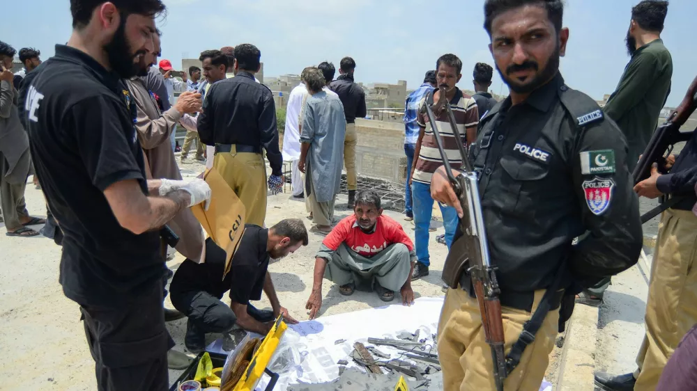 A member of the Crime Scene Unit (CSU) inspects the fragments, of what they say is a drone, after it was brought down, on the outskirts of Karachi, Pakistan May 8, 2025. REUTERS/Imran Ali