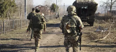 In this photo taken from video distributed by Russian Defense Ministry Press Service on Friday, March 14, 2025, Russian soldiers patrol an area in the Kursk region of Russia after it was taken over by Russian troops. (Russian Defense Ministry Press Service via AP)