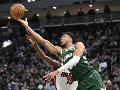 Apr 26, 2023; Milwaukee, Wisconsin, USA; Milwaukee Bucks forward Giannis Antetokounmpo (34) lays up a shot against Miami Heat center Bam Adebayo (13) during game five of the 2023 NBA Playoffs at Fiserv Forum. Mandatory Credit: Michael McLoone-USA TODAY Sports