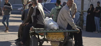 Relatives transport the body of a man killed in an overnight Israeli airstrike on a UN school, using a horse cart for burial in Deir al-Balah, in the central Gaza Strip, Wednesday, May 7, 2025. (AP Photo/Abdel Kareem Hana)