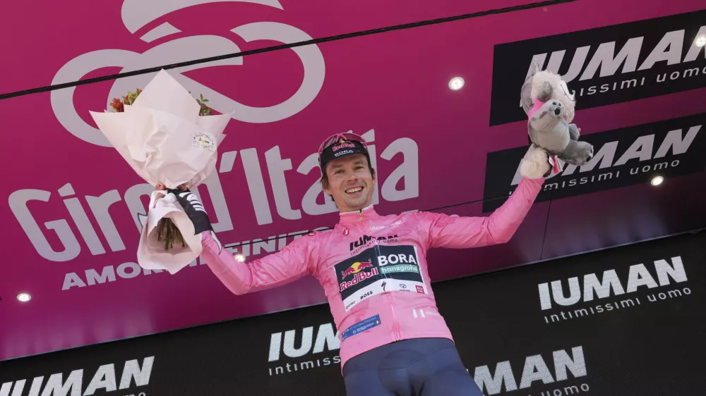 Slovenia's Primoz Roglic celebrates on the podium after earning the pink jersey of overall leader after the time trial stage 2 of the Giro d'Italia cycling race, in Tirana, Albania, Saturday, May 10, 2025. (Gian Mattia D'Alberto/LaPresse via AP)
