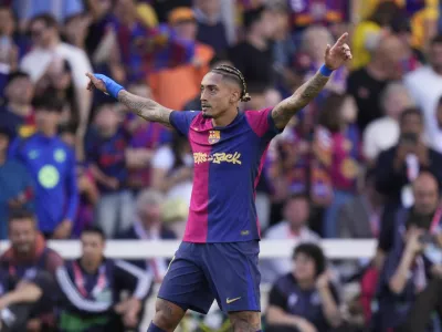 Barcelona's Raphinha celebrates scoring his side's 4th goal during the Spanish La Liga soccer match between Barcelona and Real Madrid at the Lluis Companys Olympic Stadium in Barcelona, Spain, Sunday, May 11, 2025. (AP Photo/Jose Breton)