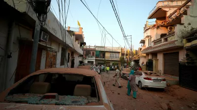 Damaged vehicles are seen in the neighbourhood, following Pakistan's military operation against India, in Rehari, Jammu, May 10, 2025. REUTERS/Stringer