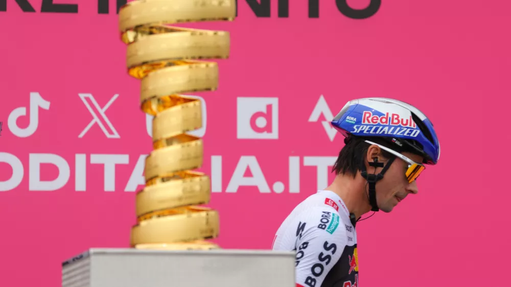 09 May 2025, Albania, Durres: Red Bull-Bora-Hansgrohe's Slovenian rider Primoz Roglic walks past the Giro d'Italia trophy prior to the first stage of the 108th Giro d'Italia cycling race, 160km from Durres to Tirana. Photo: Armando Babani/ZUMA Press Wire/dpa