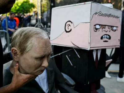 A puppet depicting Russian President Vladimir Putin and a figure with a box painted with a cartoon depicting Slovakian Prime Minister Robert Fico are prepared for an art performance held during an anti-government protest, in Bratislava, Slovakia, May 9, 2025. REUTERS/Radovan Stoklasa