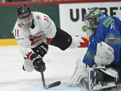 Canada's Travis Konecny and Slovenia's goal keeper Lukas Horak during the IIHF Ice Hockey World Championship group A match between Slovenia and Canada at Avicii Arena in Stockholm, Sweden, Saturday May 10, 2025. (Fredrik Sandberg/TT News Agency via AP)
