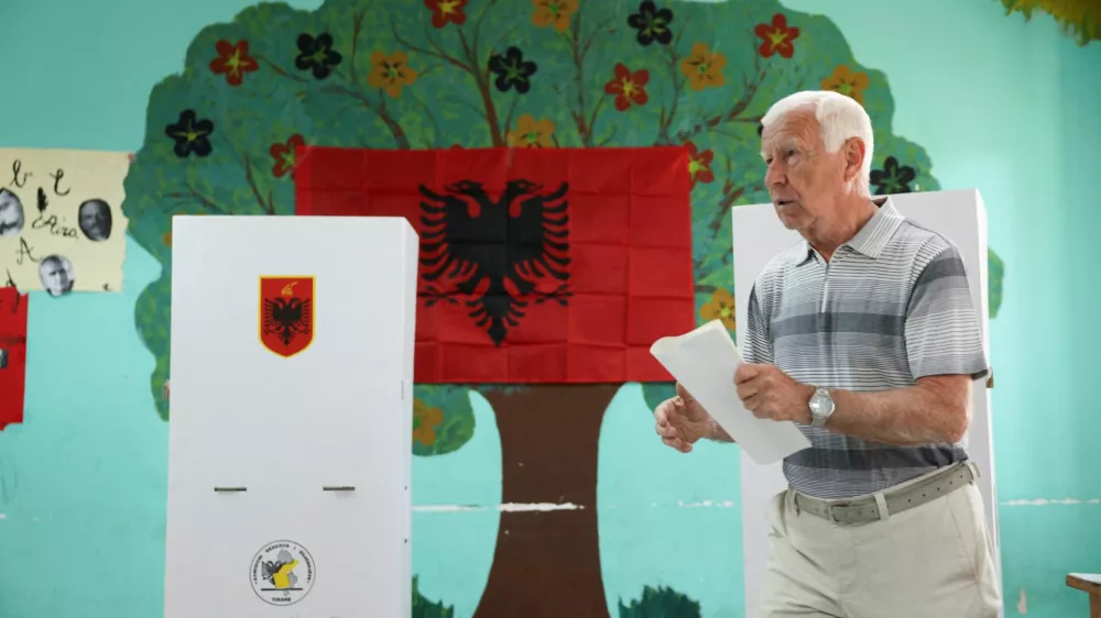 A man walks at a polling station during parliamentary election in Tirana, Albania, May 11, 2025. REUTERS/Florion Goga