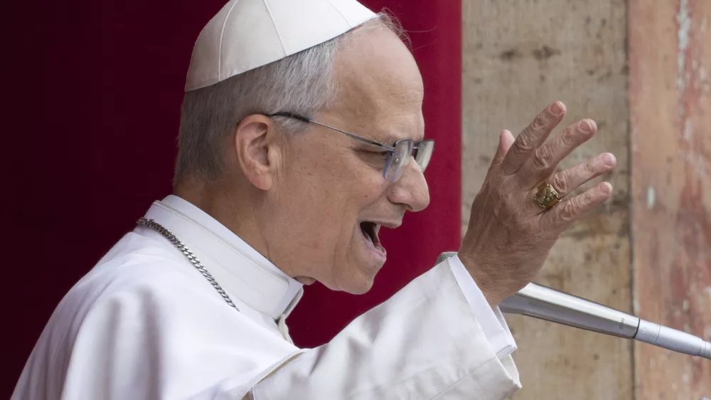 Pope Leo XIV speaks from the central balcony of St. Peter's Basilica from where he delivered his first Sunday blessing since his election to the faithful gathered in St. Peter's Square for the traditional Regina Caeli prayer at noon, on Sunday, May 11, 2025. (AP Photo/Domenico Stinellis)