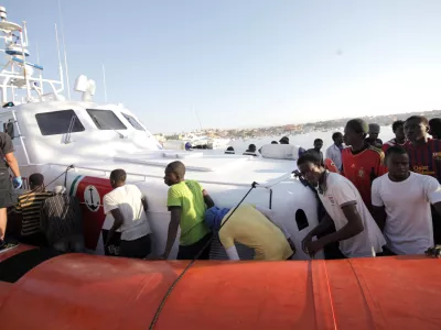 ﻿Migrants prepare to disembark in the island of Lampedusa, Italy, Wednesday, Aug. 7, 2013, after being rescued at sea by the Italian Coast Guard. Thousands of migrants heading to Europe arrive in Malta and Italy each year, often aboard unseaworthy boats. The Italian government has agreed to accept 102 migrants rescued at sea by a tanker that has been denied entry to Malta for two days. (AP Photo/Francesco Malavolta)