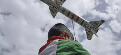 A boy draped in a Palestinian flag carries a mock rocket during a weekly anti-U.S. and anti-Israel rally organized by Houthi supporters in Sanaa, Yemen, Friday, May 9, 2025. (AP Photo/Osamah Abdulrahman)