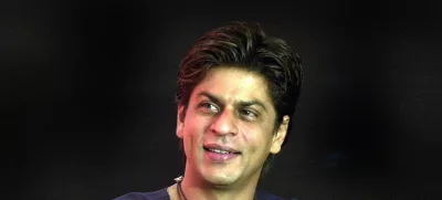 ** FILE ** Bollywood actor Shah Rukh Khan smiles during the launch of the "confidence plan" for hearing impaired by an Indian cellular company in Bombay, India, in this May 20, 2004 file photo. Bollywood leading man Shah Rukh Khan says he felt uncomfortable taking on the role of a husband who leaves his wife and child for another woman in his latest film. (AP Photo / Aijaz Rahi, file)