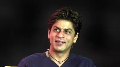 ** FILE ** Bollywood actor Shah Rukh Khan smiles during the launch of the "confidence plan" for hearing impaired by an Indian cellular company in Bombay, India, in this May 20, 2004 file photo. Bollywood leading man Shah Rukh Khan says he felt uncomfortable taking on the role of a husband who leaves his wife and child for another woman in his latest film. (AP Photo / Aijaz Rahi, file)