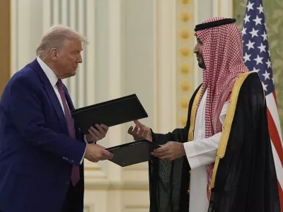 President Donald Trump and Saudi Crown Prince Mohammed bin Salman exchange documents during a signing ceremony at the Royal Palace, Tuesday, May 13, 2025. (AP Photo/Alex Brandon)