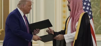 President Donald Trump and Saudi Crown Prince Mohammed bin Salman exchange documents during a signing ceremony at the Royal Palace, Tuesday, May 13, 2025. (AP Photo/Alex Brandon)